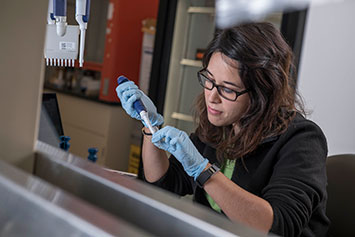 Woman holding a pipette. Link to Gifts of Real Estate Woman holding a pipette. Link to Gifts of Real Estate